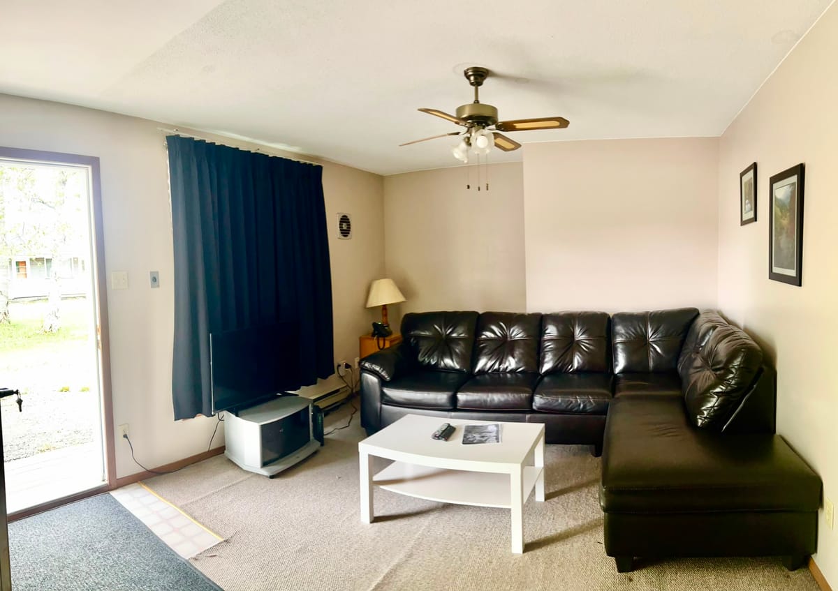 Living room with a leather sectional sofa in a 2 Queen Bedroom Apartment at Birch Grove