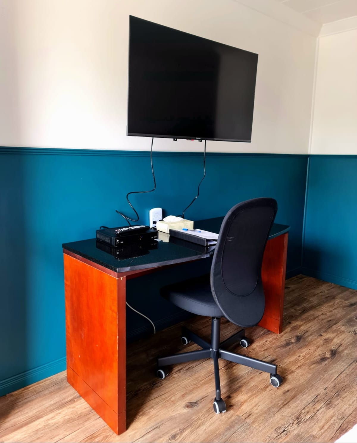 Work desk and wall-mounted swivel TV in a Norwest Standard King room